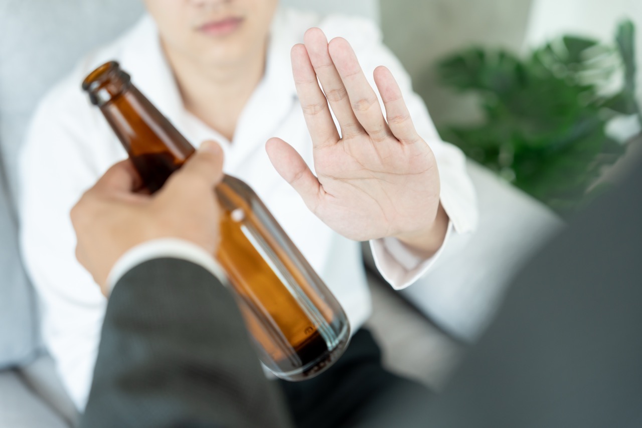 man refuses say no and avoid to drink an alcohol , hand show reject and stopping, alcoholism treatment, alcohol addiction, quit booze, Stop Drinking Alcohol. Refuse bottle liquor, unhealthy